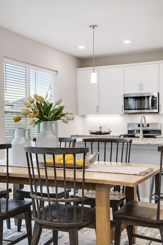 dining space featuring recessed lighting