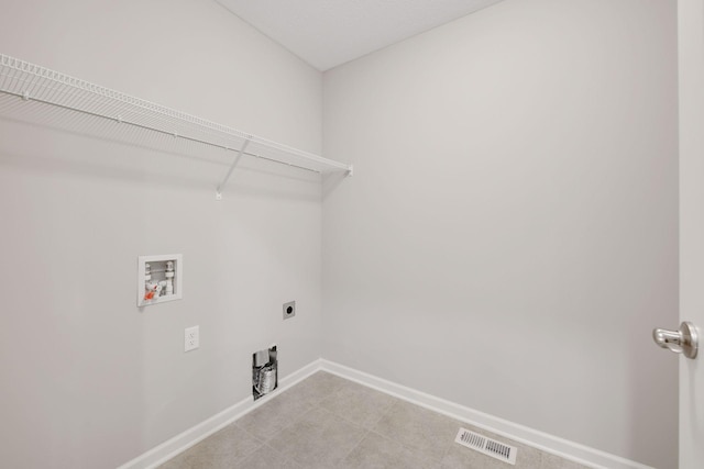 washroom featuring laundry area, baseboards, visible vents, hookup for a washing machine, and electric dryer hookup