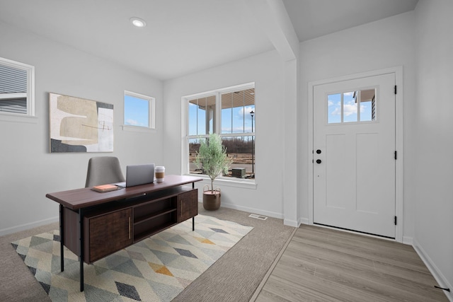 foyer entrance featuring visible vents, baseboards, light wood-style flooring, and recessed lighting