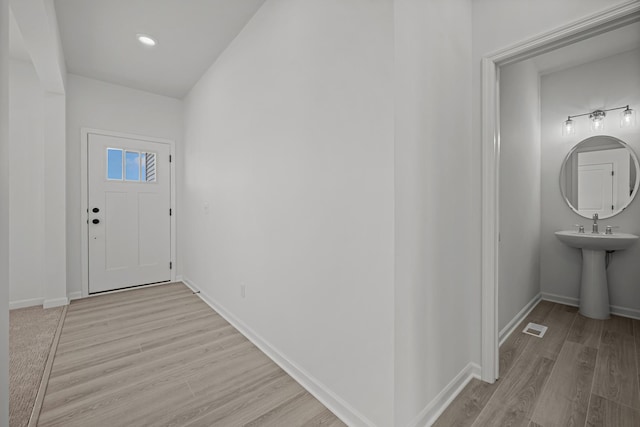 entrance foyer with baseboards, visible vents, and light wood-style floors