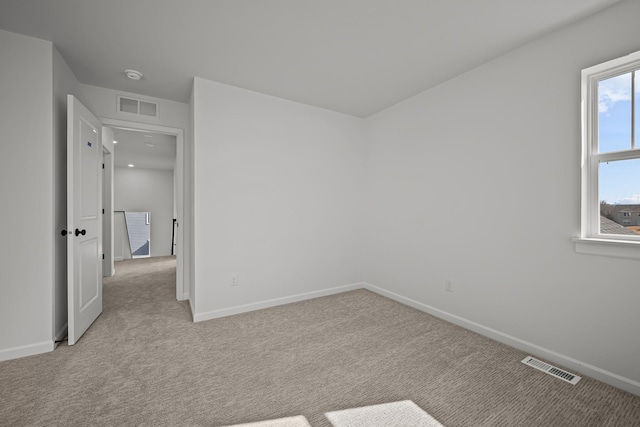 unfurnished bedroom featuring light carpet, visible vents, and baseboards