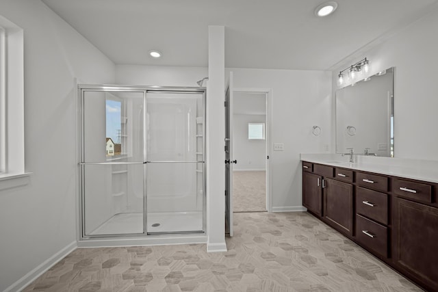 full bath with recessed lighting, a shower stall, vanity, and baseboards