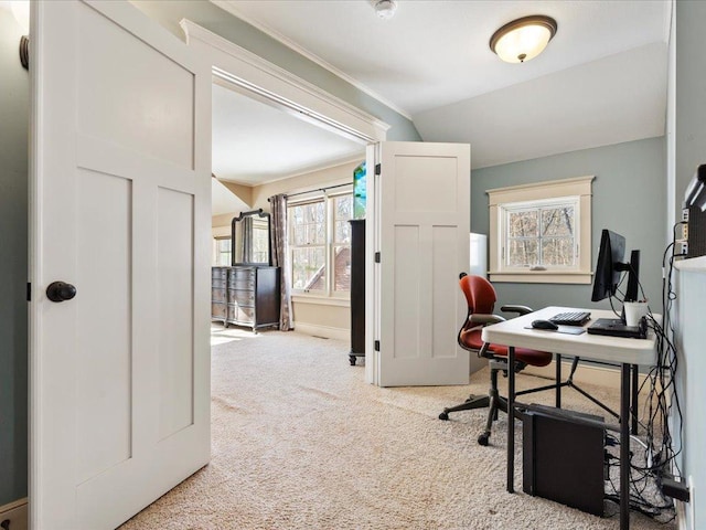 carpeted home office featuring crown molding and baseboards