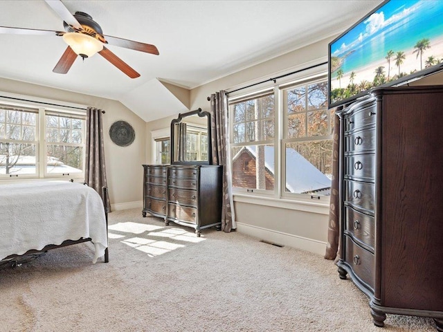 bedroom with light carpet, visible vents, baseboards, a ceiling fan, and vaulted ceiling