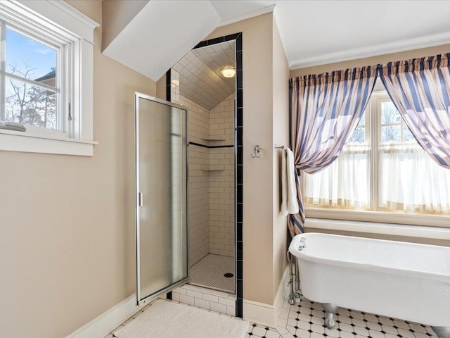 full bath featuring a freestanding tub, vaulted ceiling, a shower stall, and baseboards