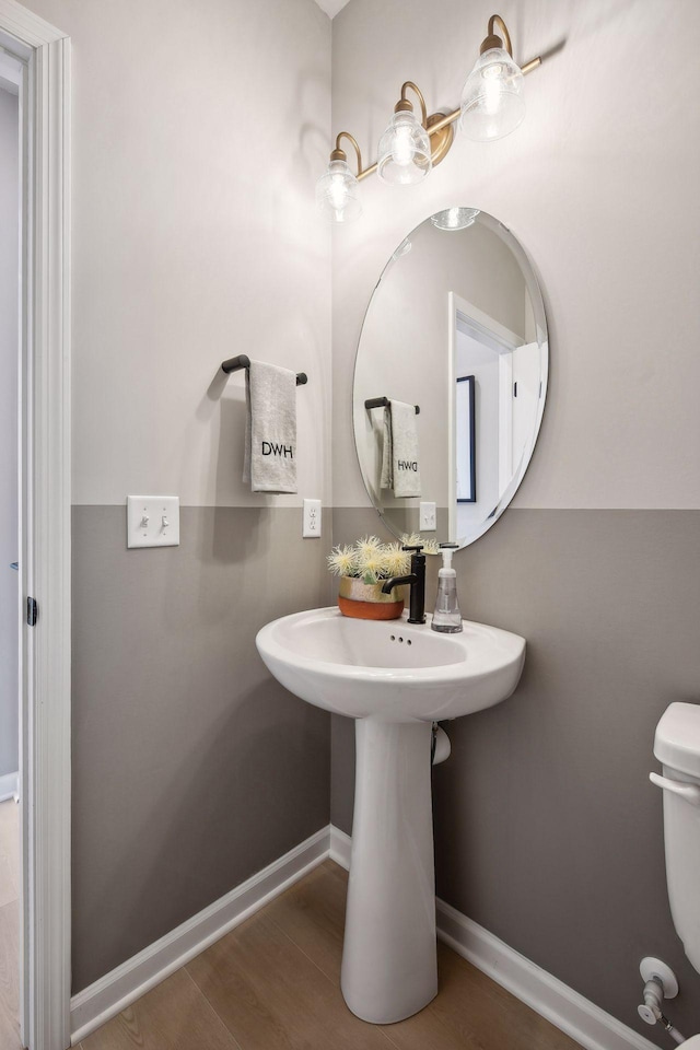 bathroom with hardwood / wood-style floors