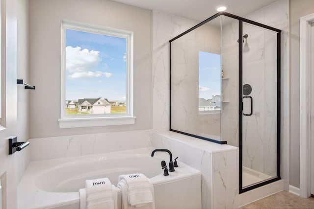 bathroom with plenty of natural light and shower with separate bathtub