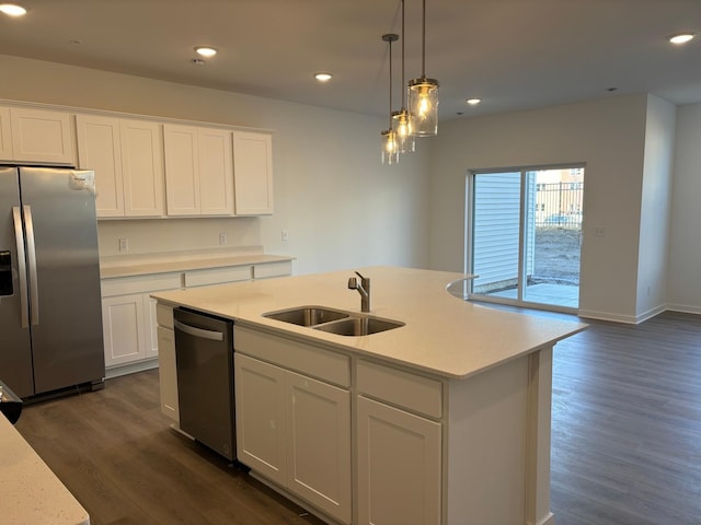 kitchen with sink, white cabinetry, dark hardwood / wood-style floors, stainless steel appliances, and a kitchen island with sink