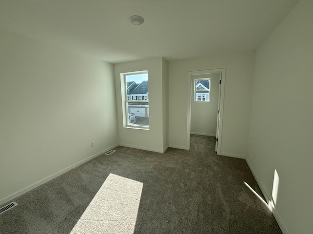 interior space with carpet, visible vents, and baseboards