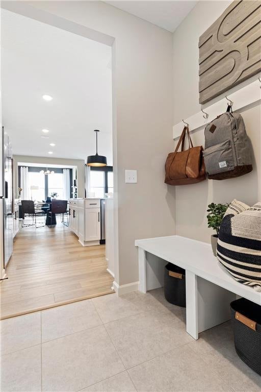 mudroom featuring recessed lighting, baseboards, and light tile patterned floors