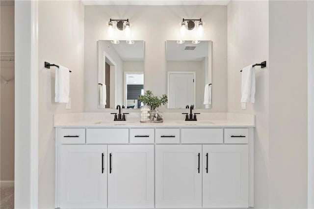 full bathroom with double vanity and a sink