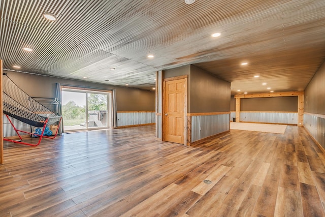 interior space with wood-type flooring, wooden walls, and wood ceiling