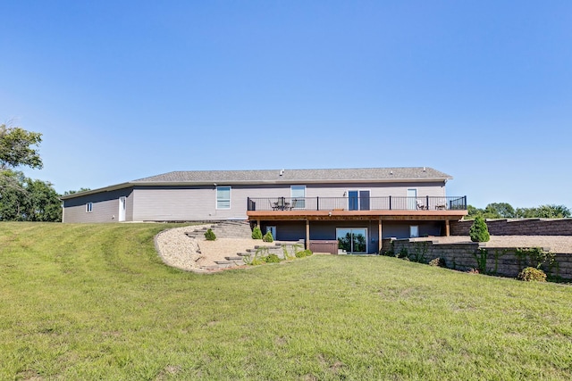 rear view of house featuring a wooden deck and a yard