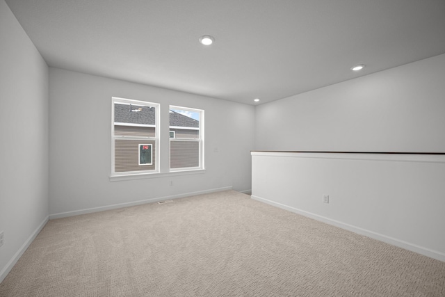 unfurnished room with light carpet, baseboards, and recessed lighting