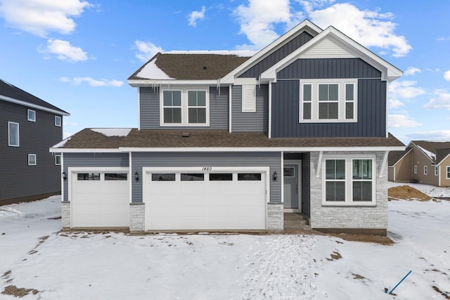 view of front of house featuring stone siding, board and batten siding, and roof with shingles