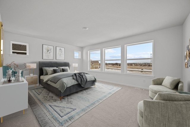 bedroom featuring carpet floors, visible vents, and baseboards