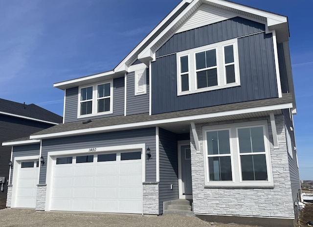 view of front facade with stone siding and an attached garage