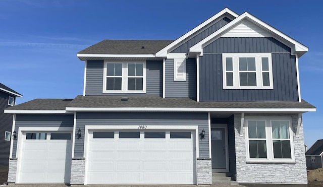 craftsman house featuring an attached garage, stone siding, a shingled roof, and board and batten siding