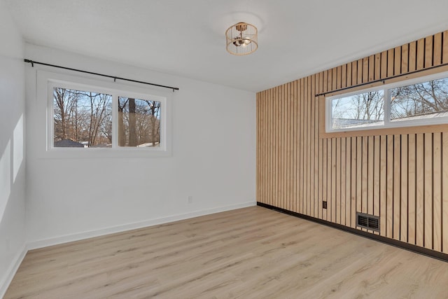 empty room with light hardwood / wood-style floors