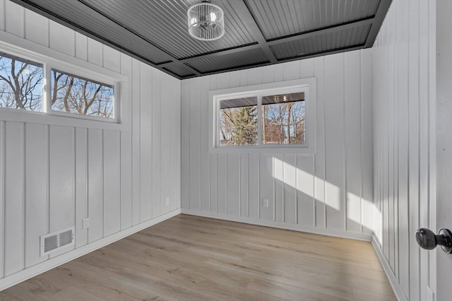 unfurnished room with a healthy amount of sunlight and light wood-type flooring