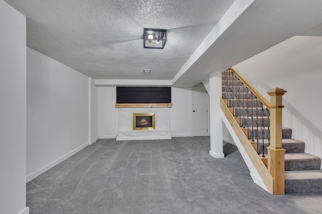 unfurnished living room with carpet floors and a textured ceiling