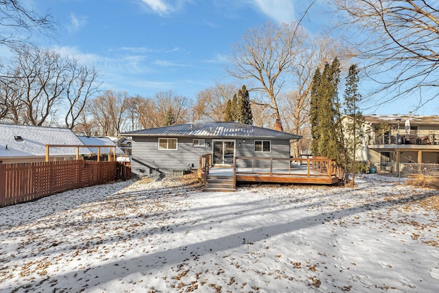 snow covered property featuring a wooden deck