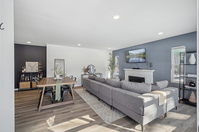 living area featuring recessed lighting, a fireplace, and light wood-style floors