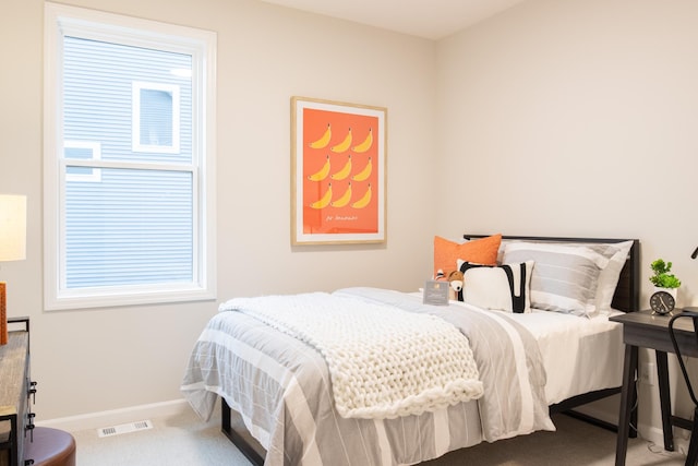 bedroom with baseboards, visible vents, and carpet flooring