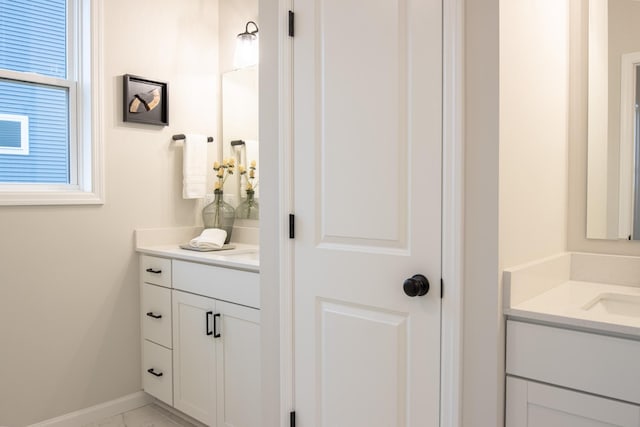 bathroom featuring vanity and baseboards