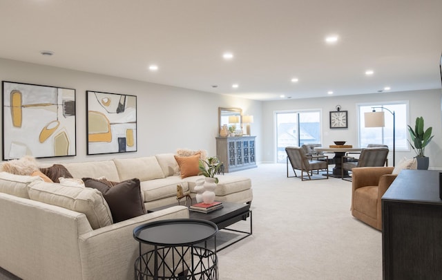 living room with recessed lighting and light carpet