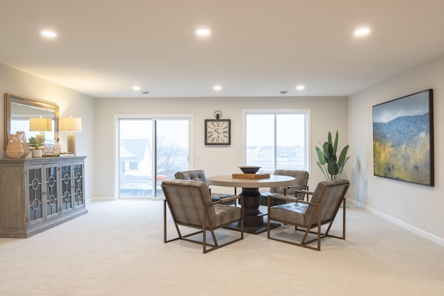 dining space with recessed lighting, a wealth of natural light, and light colored carpet