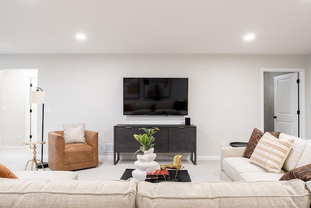 living room with carpet floors, recessed lighting, visible vents, and baseboards