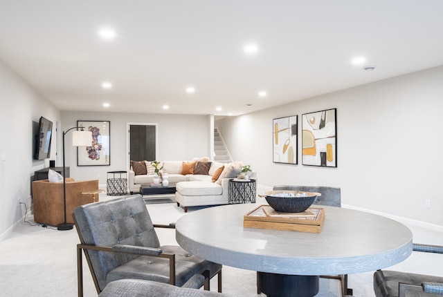 dining space featuring baseboards, stairway, recessed lighting, and light colored carpet