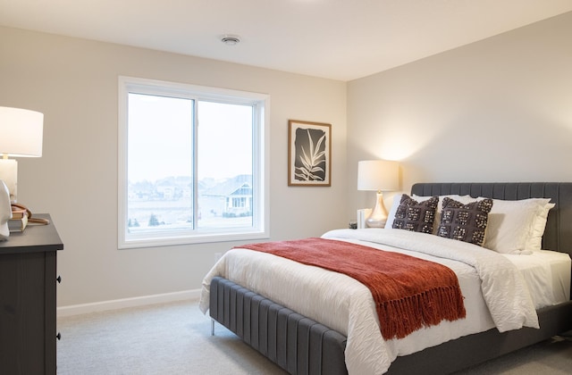 carpeted bedroom featuring baseboards