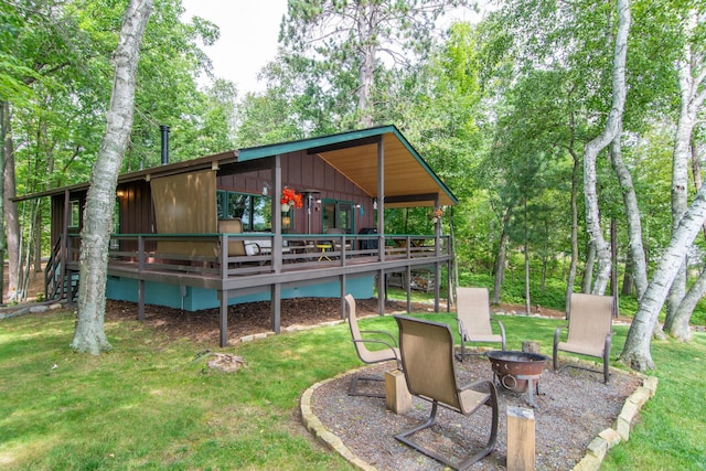 view of yard featuring a wooden deck and a fire pit