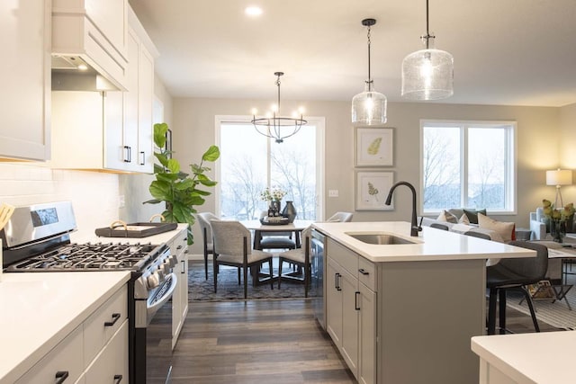 kitchen with stainless steel appliances, a sink, and light countertops