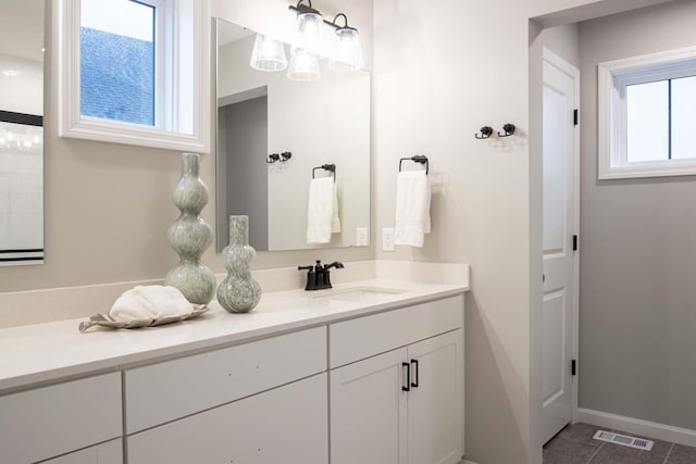 bathroom with visible vents, tile patterned floors, vanity, and baseboards