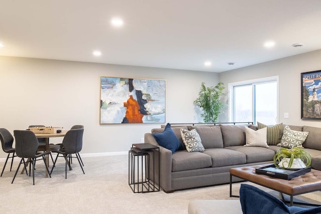 living room featuring recessed lighting, light colored carpet, and baseboards