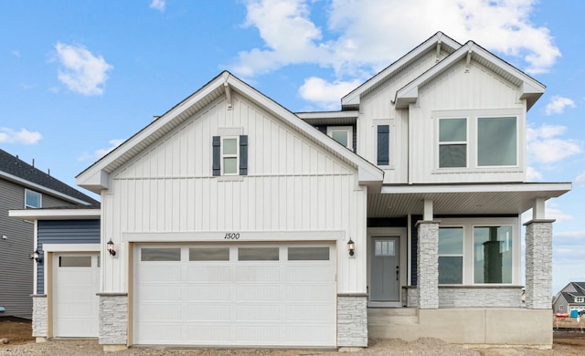 view of front of house featuring stone siding, board and batten siding, and an attached garage