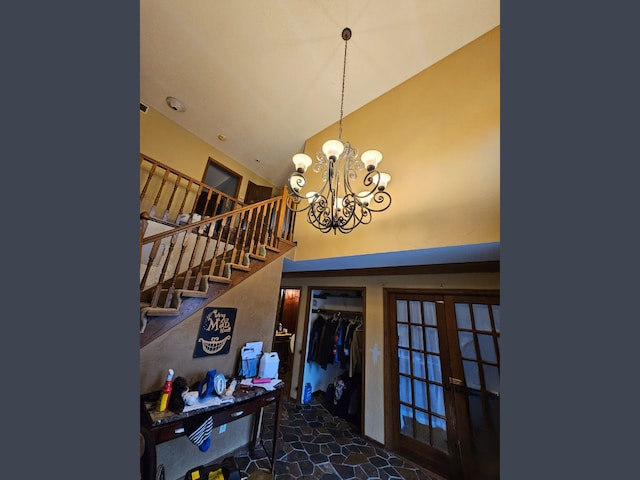 staircase featuring a notable chandelier and french doors