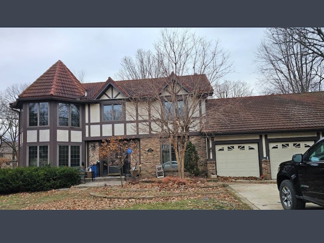 tudor-style house featuring a garage