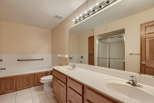 full bathroom with toilet, shower with separate bathtub, a textured ceiling, vanity, and tile patterned flooring