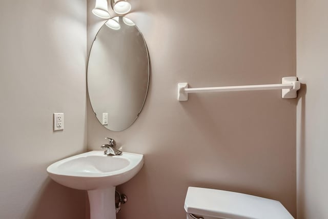 half bathroom featuring toilet