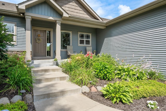 view of exterior entry featuring board and batten siding