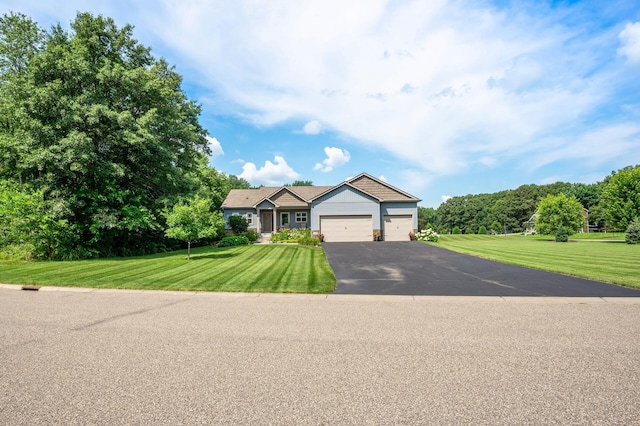 single story home featuring driveway, an attached garage, and a front yard