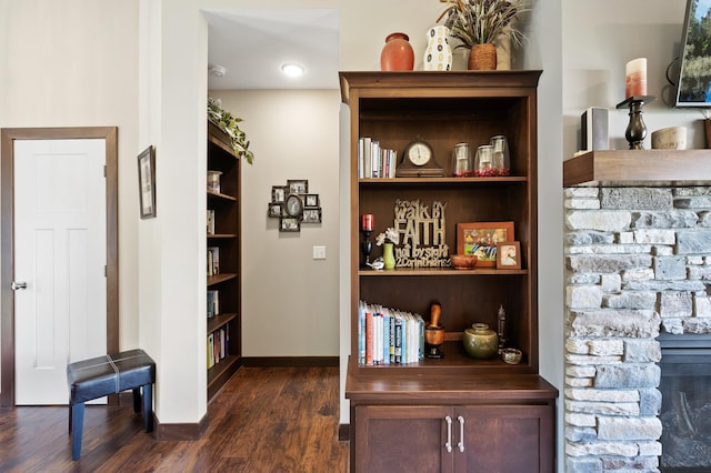 interior space with dark wood-style floors, baseboards, and built in features