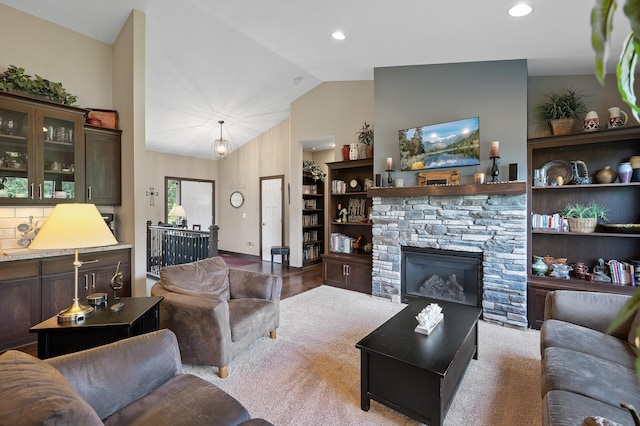 living area with a fireplace, vaulted ceiling, and recessed lighting