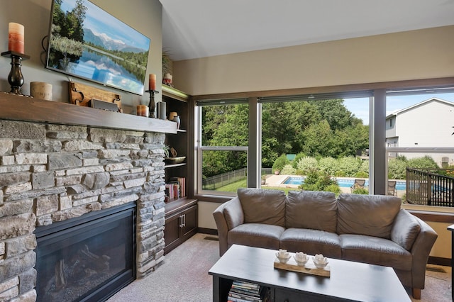 sunroom / solarium with a wealth of natural light and a stone fireplace