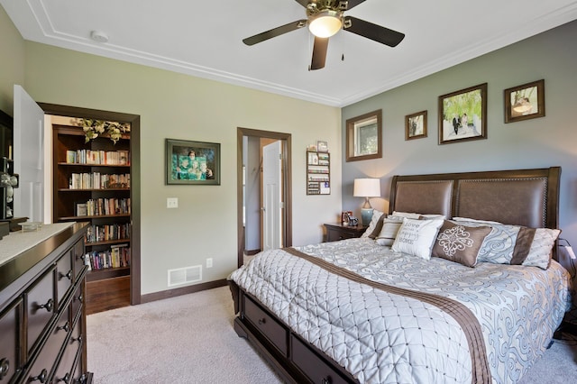 carpeted bedroom featuring a ceiling fan, visible vents, and baseboards