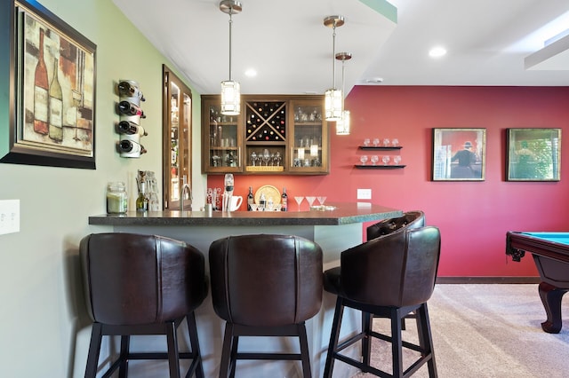 bar featuring a bar, carpet flooring, decorative light fixtures, and recessed lighting